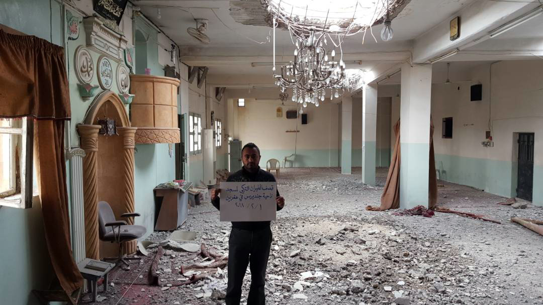 A civilian holding a banner that says, 